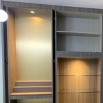 White tiltable downlight aimed into a built-in display cabinet