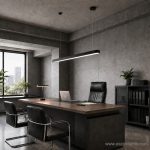 Black office table linear hanging light suspended over a large executive desk in a modern concrete workspace.