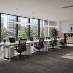White office linear pendant light fixtures suspended over open-plan corporate workstations.