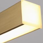 Macro close-up side view showing the premium brushed metal frame and frosted acrylic diffuser of the gold LED hanging light with remote.