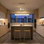 white linear minimalist hanging light in modern kitchen island setup
