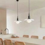 Two Lucien layered glass pendant lights above a modern dining table