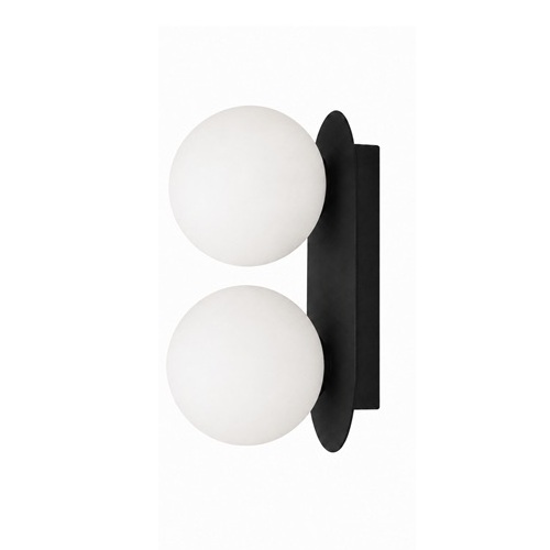 Matte black double globe wall sconce mounted on a white wall with light-diffusing frosted glass orbs.