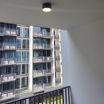 Minimalist black surface mount downlight installed on sheltered balcony ceiling