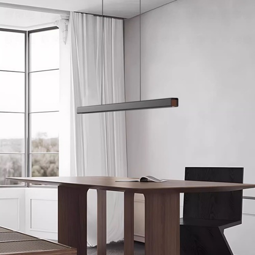 Modern black linear pendant light above dining table