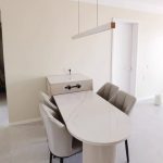 White linear pendant light above dining table