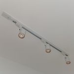 Flush ceiling mounted white track and rail lighting layout showing multi-directional track spotlights.