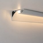 Close-up of the Arclux-Contour coveless aluminium profile configured in a downward wall-wash installation orientation.