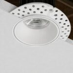 Before and after plaster installation of a trimless recessed downlight for false ceiling