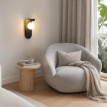 Black minimalist wall light in a cosy reading corner