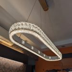 oblong rectangular crystal pendant light close-up with clear crystals and gold frame