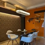 oblong rectangular crystal pendant light above black dining table in Singapore condo.