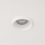Matt white fixed recessed downlight installed flush on false ceiling.