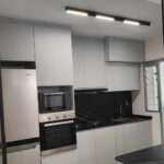 Linear diffused magnetic track lights above a Singapore BTO kitchen counter