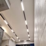 Black magnetic linear diffused track lights in a Singapore condo living room