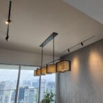Recessed magnetic track with black spotlights in Singapore condo dining area
