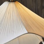 Close-up of fine pleated fabric and curved edge of Japandi Plisse pendant light