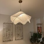 Plisse fabric pendant light installed in a home with warm ambient lighting