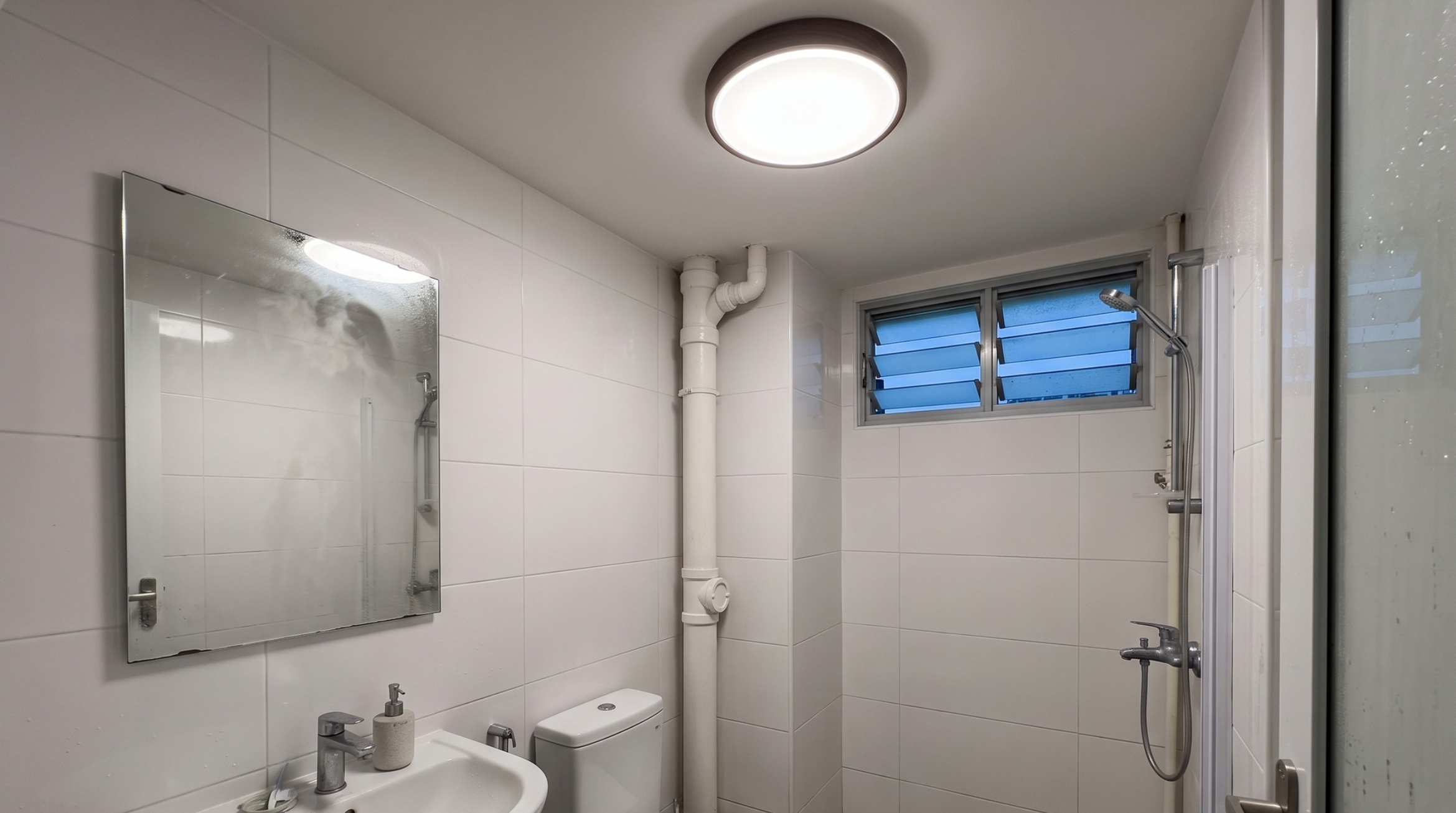 Round toilet light installed in a Singapore HDB bathroom ceiling